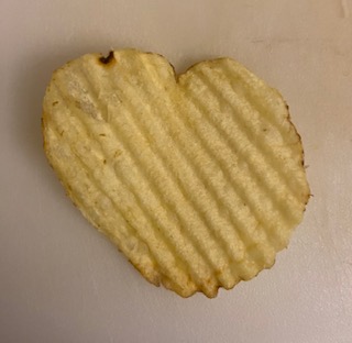 Photo of a Ruffles potato chip that is shaped like a heart