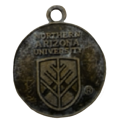 Photo of one side of a Northern Arizona University charm. It has the university name and emblem on it